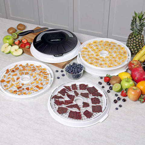 Electric Food Dehydrator With Four Stackable Trays And Top Mounted Fan displaying dried fruits, beef jerky, and fresh produce.