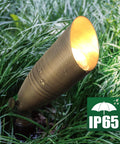 Outdoor view of a brass spotlight from the 12 Pack Solid Brass Landscape Spotlight Kit 12V AC DC Low Voltage Outdoor Uplight With ABS Ground Spike Waterproof Directional LED Fixture MR16 Bulb Not Included.