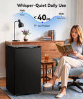 Compact 3.0 Cubic Foot Upright Mini Freezer In Black, quiet operation under 40dB, in a cozy living room setting.