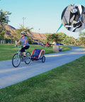 Person cycling in park with bike trailer hitch connector and cycling adapter for kids trailers, cargo, and pet trailers, close-up view.
