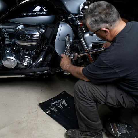 Mechanic using tools from Heavy Duty 24 oz Canvas Large Wrench Roll Tool Bag For Large Wrenches With 3 Grommets For Hanging Storage