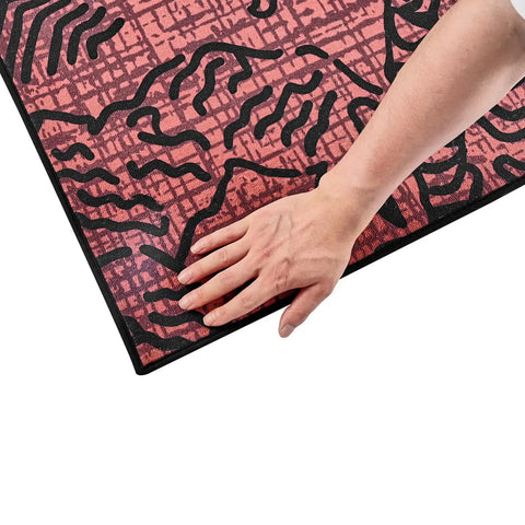 Hand pressing rug using Rug Gripper 20 Pack With Strong Adhesive And Residue Free Double Sided Non Slip Carpet Stickers for area rugs.