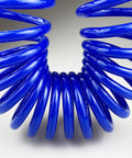 Close-up of a coiled blue Flexible Polyurethane Recoil Air Hose, One Quarter Inch Inner Diameter, Ten Feet With Bend Restrictor
