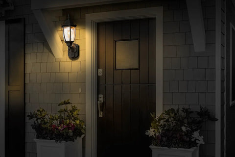 Six Sided Die Cast Aluminum Lantern With Beveled Glass Black Motion Activated Outdoor Light illuminating entryway