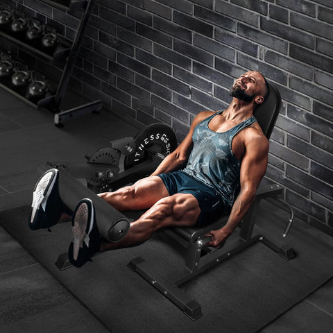 Man using 2 In 1 Leg Extension And Curl Machine For Home Gym Full Leg Day Trainer That Targets Quads And Hamstrings with black finish.