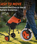 Person moving Powerful 15 Amp Electric Wood Chipper Shredder With 1.75 Inch Cutting Capacity For Branches and Twigs in garden