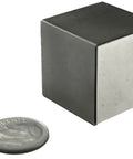 Heavy Duty 1 Inch Neodymium Magnet Cube For Engineering And Fabrication, Testing And Industrial Holding Tasks NdFeB Rare Earth Block With 150 Lb Pull Force next to a coin for size comparison.