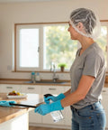 Person cleaning kitchen wearing Breathable Disposable Bouffant Cap With Elastic Edge For A Secure Fit Latex Free Hair Net