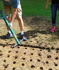Person using Five In One Lawn And Garden Tool For Easy Planting And Weeding Bulb Planter Sod Plugger Weeder Annual Planter And Soil Tester Dig Two One Eighth Inch Holes Quickly From A Comfortable Standing Position No Bending Over With Soil Storage on lawn with holes