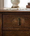 Vintage Twisted Ribbon Cabinet Pull Set in Antique Bronze on wooden drawer, showcasing single hole installation.