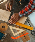 Woodworker using measuring tools next to Lightweight Woodworking Push Block With Handle Portable Safety Push Stick For Table Saw Carpentry Projects Orange Tool Pro Grade Grip For Precision Panel Work And DIY Machining.