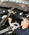 Mechanic installing Heavy Duty Exhaust Hangers 2 Pack Flexible Swivel Muffler Tail Pipe Bracket under a car