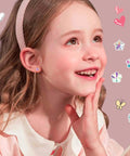 Flat Back Stud Earrings Set for Women and Girls, Hypoallergenic Stainless Steel, 16 Pairs of Tiny CZ Cartilage Studs in Star, Heart, Flower and Ball Styles, Minimalist Everyday Wear Earrings for All Occasions. Girl wearing tiny heart stud