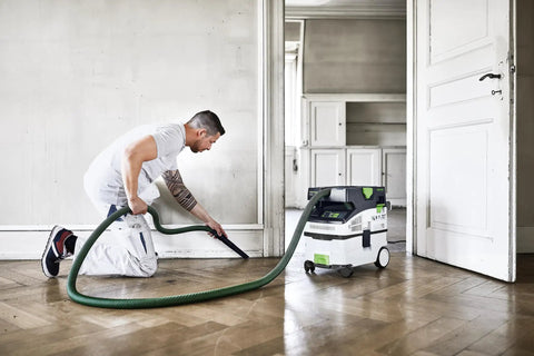 Man using CT MIDI I Dust Extractor With HEPA Filter, Bluetooth Start, AutoClean System, Heavy Duty Suction Power, and Touch Controls