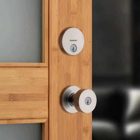 991 Pismo Keyed Entry Knob and Single Cylinder Deadbolt Combo Pack With SmartKey Microban Satin Nickel Finish shown on wooden door