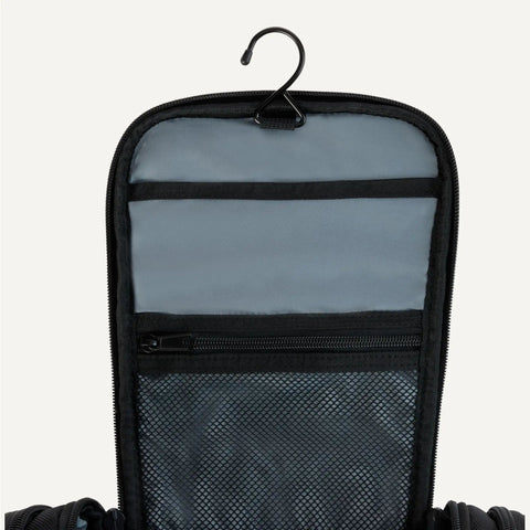 Spacious Hanging Toiletry Bag With Durable 1680D Polyester Large Capacity Dopp Kit Multiple Compartments Leakproof Lining Must Have Travel Organizer Black showing open top with hook and mesh pocket