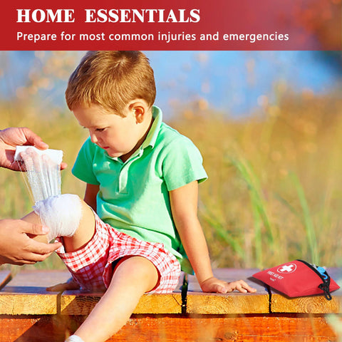 Atickyaid mini first aid kit red pouch with white cross; child seated outdoors while knee is bandaged.