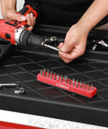 Red One Quarter Inch Hex Bit Organizer With Magnetic Base And Rubber Pad Toolbox Essential 43 Hole Bit Holder on workbench