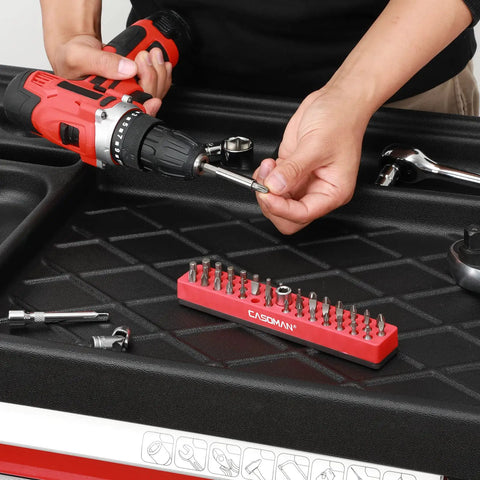 Red One Quarter Inch Hex Bit Organizer With Magnetic Base And Rubber Pad Toolbox Essential 43 Hole Bit Holder on workbench