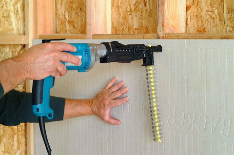 Person using drill with collated fiber cement board screws for easy countersinking and alternating high low threads on cement board.
