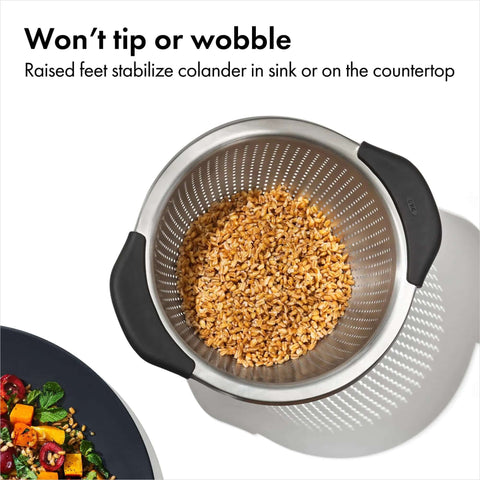 Top view of Non Slip Grip 5 Qt Stainless Steel Colander with Comfortable Handles containing grains, showing durable nesting strainer.