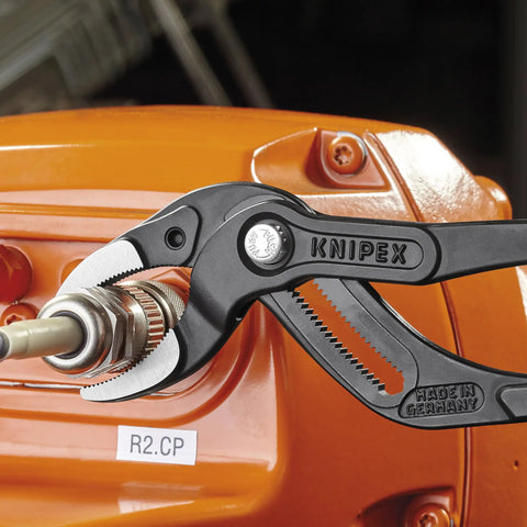 10 Inch Pipe And Connector Pliers With Push Button 25 Easy Adjustments gripping a metal connector on orange machinery
