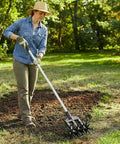 Person using Lightweight Rotary Cultivator Tiller With Adjustable Stainless Steel Poles Anti Slip Grip Hand Tiller on lawn