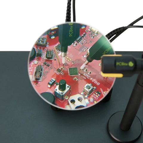 Handsfree Oscilloscope Probe SQ100 100MHz measuring PCB with spring-loaded needle and flexible grounding on workbench.
