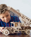 Wooden 3D Fire Truck Model Kit With Lever Operated Rotatable Retractable Ladder That Converts To A Crane multicolor DIY set, boy playing