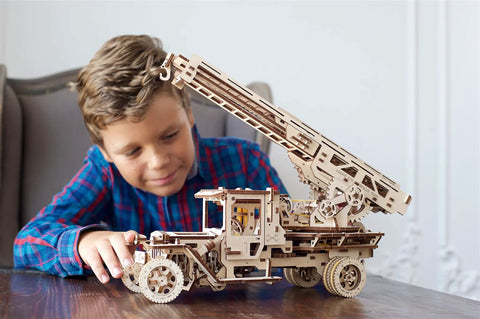 Wooden 3D Fire Truck Model Kit With Lever Operated Rotatable Retractable Ladder That Converts To A Crane multicolor DIY set, boy playing