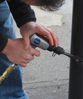 Person using ATK1002 50 Piece Ultimate Air Tool Kit With Bonus Inflation Tool For Home Garage And DIY Use on metal structure