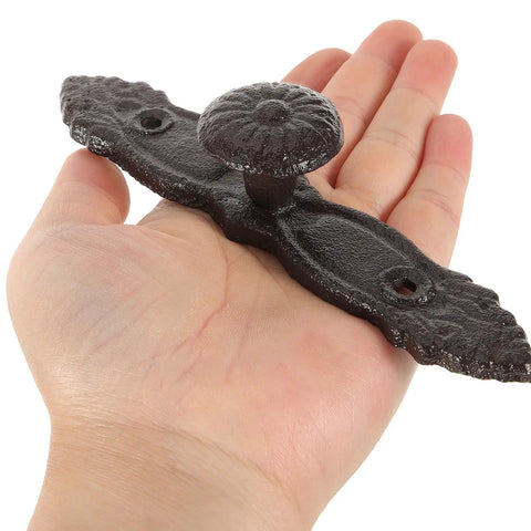 Hand holding Vintage Cast Iron Drawer Pulls For Wardrobe And Cabinets, Antique Dresser Handles, Rustic Hardware For Home Renovation.