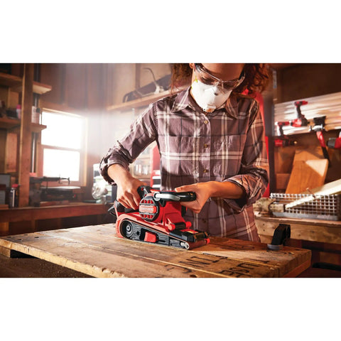 Person using Corded 7 Amp Belt Sander Workhorse With Angled 3 Inch By 21 Inch Belt For Closer Sanding in workshop