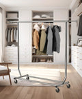 Sturdy Workhorse Commercial Grade Garment Rack With Heavy Duty Steel Construction Extends From 50 To 75 Inches Holds Up To 250 Lbs Chrome Finish Adjustable Hanging Rod For Home Office Or Studio Use shown in a room setting.