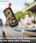 Dragon Edition 1TB Portable SSD With USB C And USB 3.2 Gen 2 shown outdoors with dragon artwork, highlighting rugged design and durability.