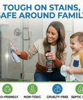 Woman using Hard Water Spot Remover For Glass Spotless X2 No Scrubbing Easy On Shower Doors Car Windows And Windshields Professional Strength 16 Ounce Removes Years Of Mineral Deposits Lime Scale Stains And Leaves Glass Sparkling Clean on shower door with child nearby.