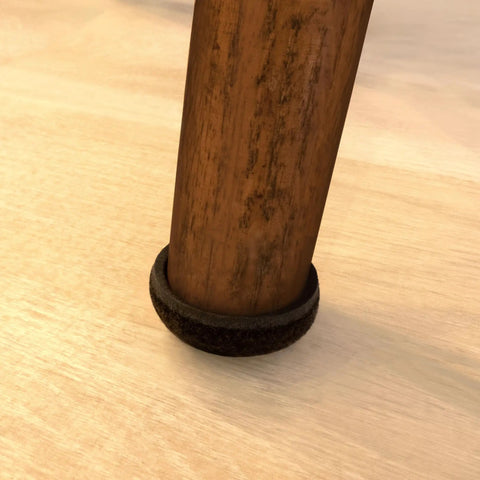 Formed Felt Furniture Sliders 1.5 Inch Protect Hardwood Floors From Scratches With Secure Grip Cup Design Walnut Brown on chair leg