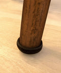 Close-up of a 1 inch round felt furniture slider installed on a wooden leg, 1 Inch Round Felt Furniture Sliders For Hardwood And Tile Surfaces Reusable Self Adhesive Moving Pads That Fit 1 Inch Legs Noise Reducing Floor Protecting Set Of 20 Brown