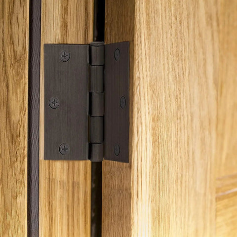 Heavy Duty 3x2 Inch Butt Hinges Black Finish 24 Pack with Plain Bearing installed on a wooden door