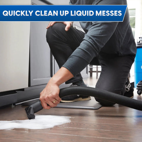 Heavy Duty 8 Gallon Wet Dry Shop Vac Delivering 75 Cfm Raw Heavy Lifting Suction For Serious Garage Cleanups Includes 17 Foot Extender Hose being used to clean liquid spills.
