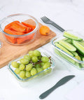 24 Piece Glass Food Storage Set With Airtight Lids BPA Free Freezer Microwave And Oven Safe Includes 12 Glass Containers holding fruit and vegetables on countertop.