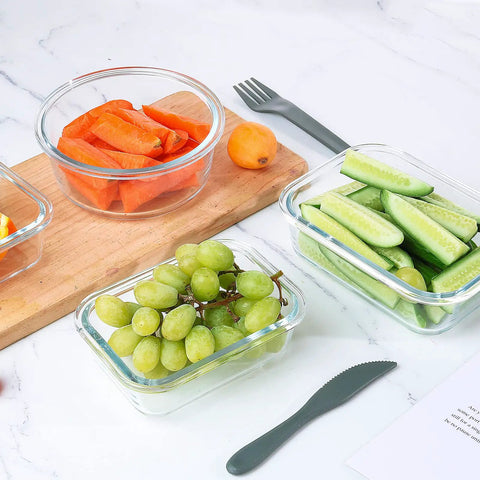 24 Piece Glass Food Storage Set With Airtight Lids BPA Free Freezer Microwave And Oven Safe Includes 12 Glass Containers holding fruit and vegetables on countertop.