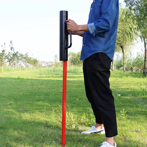 Fence Post Driver 12 Lb Heavy Duty T Post Pounder With Dual Handles Rammer in use on a red post in a grassy field