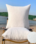 Outdoor Pillow Inserts Pack of 2, 26 by 26 Inches, Water Resistant Cushions for Patio Furniture on a beach chair