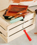 Easy Peasy Mini Paint Roller Brush With Comfy Handle For Smooth Ceiling And Cabinet Repainting next to a paint tray.