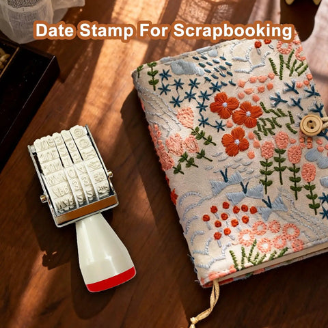 Monthly Date Stamp Set With Weather Icons And Calendar Stamps For Planners Easy Peasy Organizer Craft Supplies Hella Convenient Number Trackers That Make Daily Planning A Total Breeze Without Any Stress Or Trouble on a wooden table with a floral scrapbooking journal.