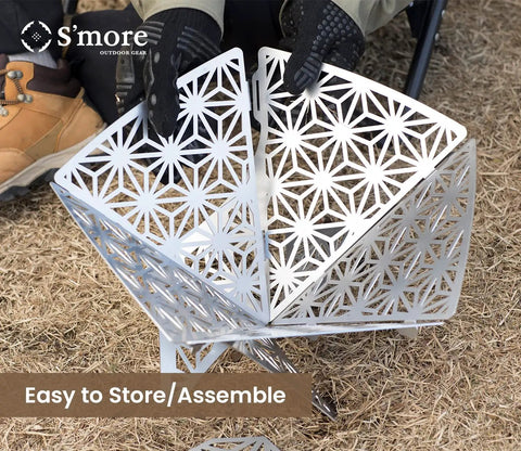 Portable Camping Fire Pit With Grill For Cooking being assembled, showcasing sturdy steel design with intricate cutout pattern.