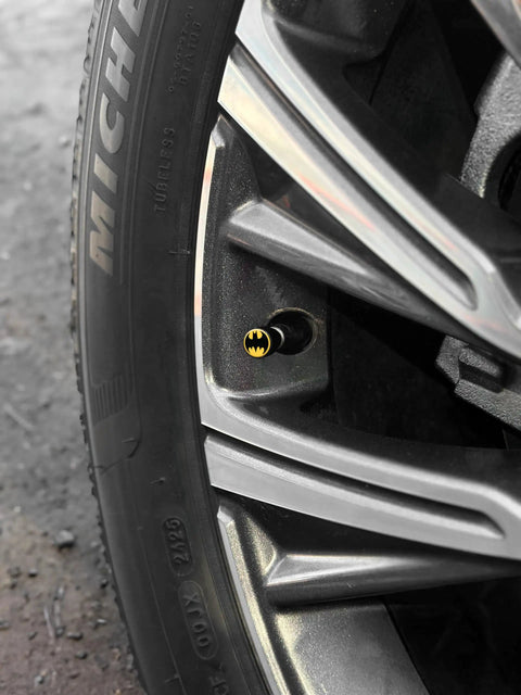 Batman Officially Licensed Tire Valve Stem Caps 4 Pack with Black Knurl Aluminum Construction on car wheel