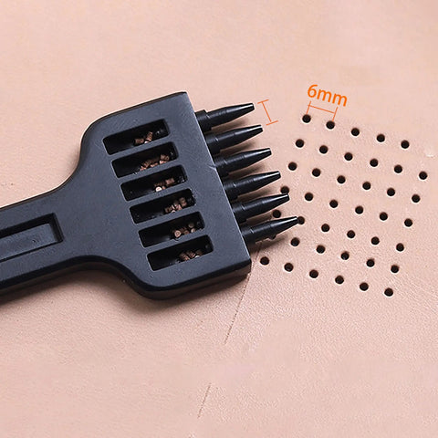Pro Grade Three Piece Leather Stitching Chisel Set With Four Millimeter Diamond Prongs shown punching holes in leather