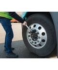 Person using Beefy Heavy Duty 40 Inch Breaker Bar With 180 Degree Swivel Head For 1 Inch Drive Chrome Vanadium Steel on truck tire